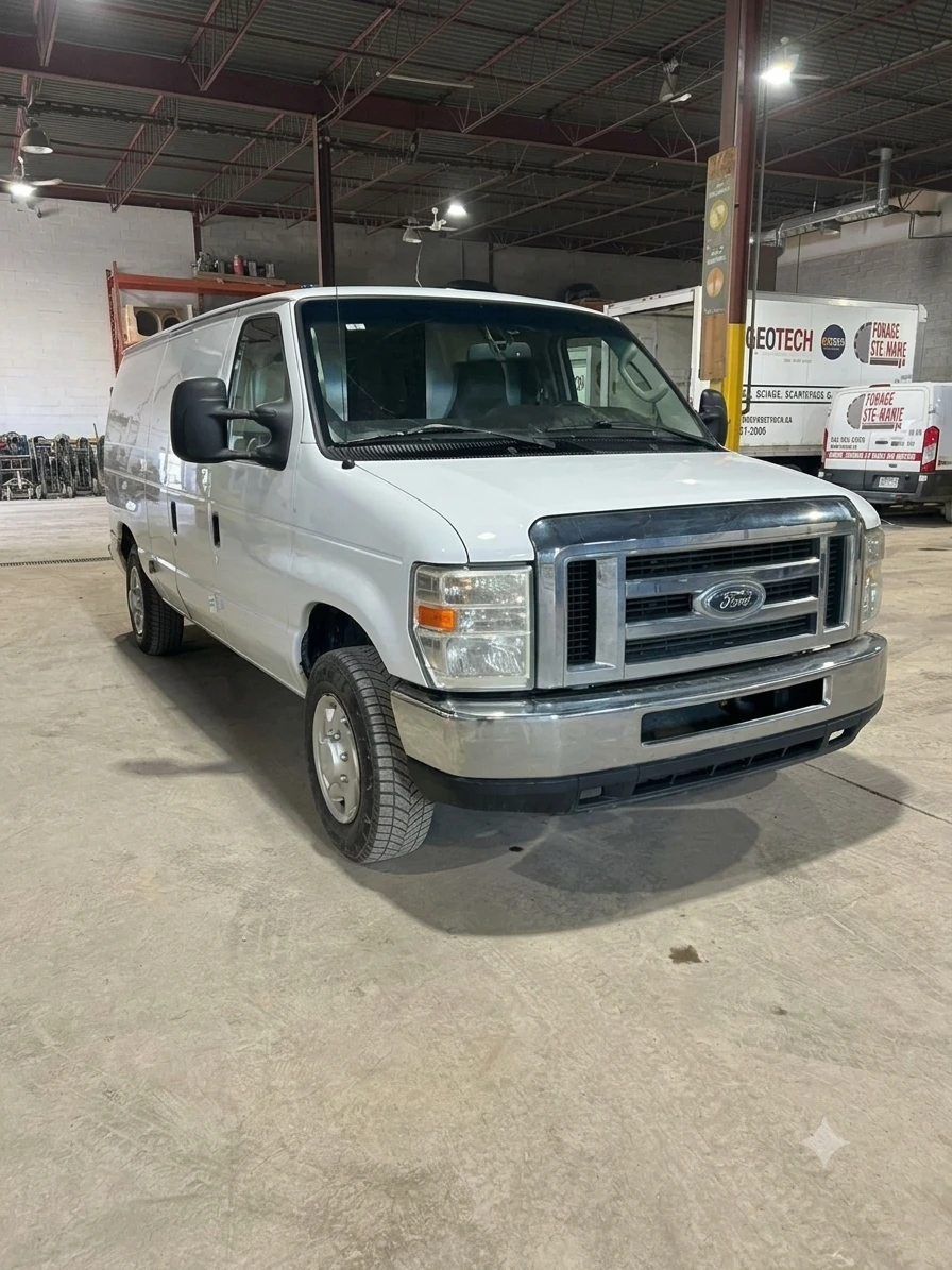 Front three-quarter view of the Ford E-150 cargo van